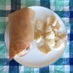 sanwich in eco takeaway paper wrap from if you care brand on a plate